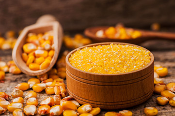 a bowl of corn is on a wooden table
