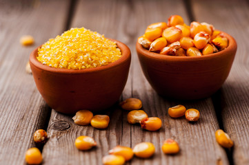 a bowl of corn is on a wooden table