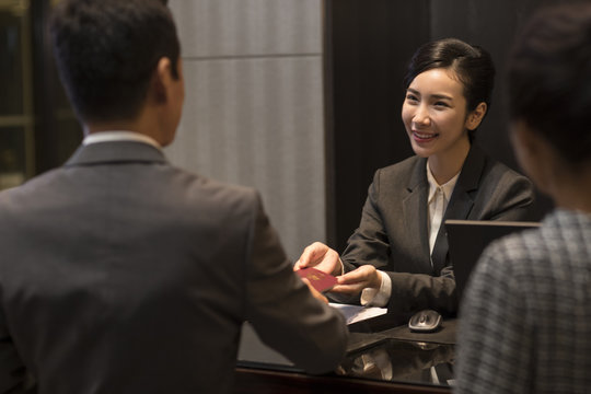 Couple checking into hotel