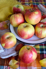 Red yellow apples on a plate on a table