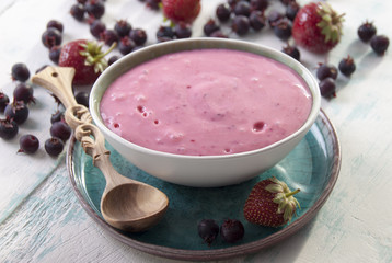 Smoothies of strawberries and irgi with yogurt in a ceramic bowl