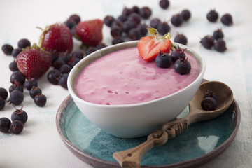 Smoothies of strawberries and irgi with yogurt in a ceramic bowl