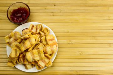 Snack on a plate. Wooden table. Salty food for beer