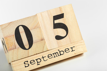 Wooden cubes with date on white background. 5th of September