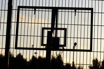 Obraz na płótnie Canvas Basketball hoop outdoor in the sunset silhouette