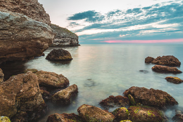 Fototapeta na wymiar Brilliant vacation destination beach sunrise and sea cliffs background