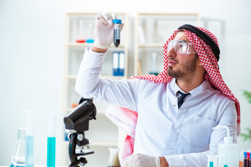 Arab chemist scientist testing quality of oil petrol