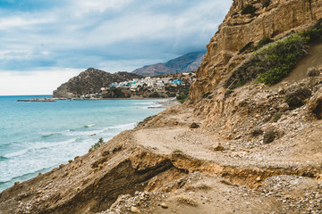 Crete, Greece. beach with rocks and cliffs with view towards sea ovean on a sunny day.