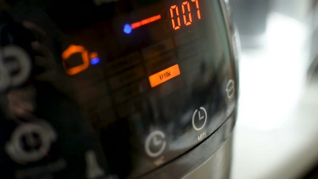 Multi-cooker LED screen display closeup while working,preparing cooking food
