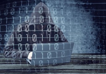 Hacker using laptop. Hacking the Internet.