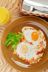 Fried eggs with vegetables and green close up top view