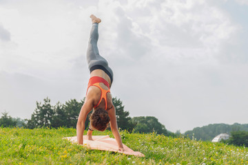 Calm and free. Dark-haired woman feeling calm and free while doing yoga enjoying warm summer morning
