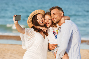 Happy family spending good time at the beach together