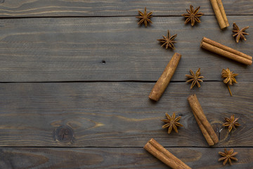 Spicy spices cinnamon sticks and star anise on dark wooden background