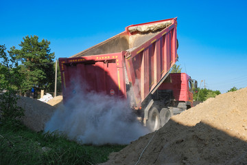 rusovich pours sand on the construction site