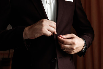 male businessman buttoning his jacket