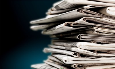 Pile of newspapers on white background