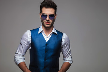 portrait of sexy young man with blue sunglasses