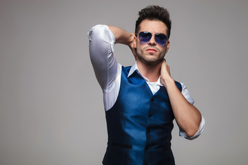 portrait of sensual man in blue vest posing seductively