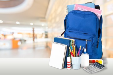School bag on wooden desk