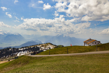 Green grass field on top of Rigi Kulm Luzern Switzerland with Alps snow mountain view a