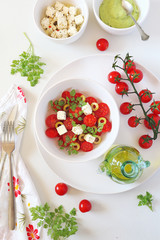 Vegetable salad with cherry tomatoes, green olives, greek cheese and olive oil