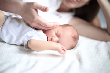 Obraz na płótnie Canvas serene newborn baby sleeps next to mom