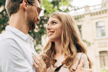 Fototapeta premium beautiful young couple looking at each other and smiling
