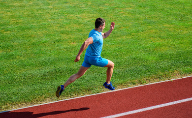 Athlete run track grass background. Sprinter training at stadium track. Runner captured in midair. Short distance running challenge. Boost speed. Run into shape. Running challenge for beginners