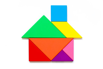 Color wood tangram puzzle in home shape on white background