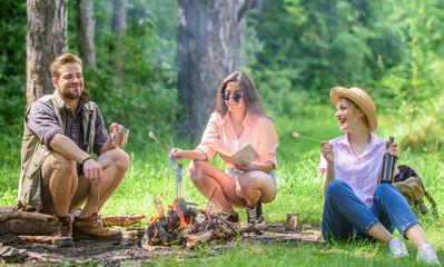 Roasted marshmallows popular sweet snack or dessert on picnic. Youth at picnic roasting marshmallows. Company friends prepare roasted marshmallows snack nature background. Spend great time on weekend