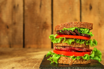 sandwich (sausage, bread, lettuce, tomatoes and more) . food background.  Top view with copy space