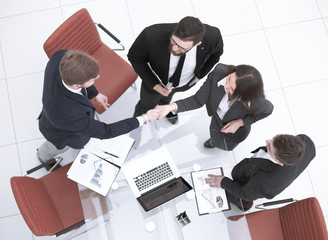 top view.handshake, businessman and business woman over a Desk