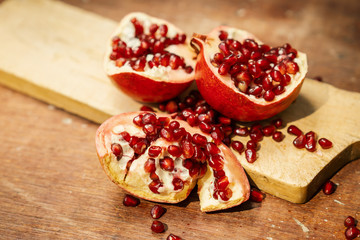 fresh pomegranate fruit on an old wooden table