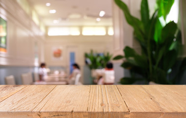 Empty dark wooden table in front of abstract blurred bokeh background of restaurant . can be used for display or montage your products.Mock up for space.