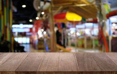Empty dark wooden table in front of abstract blurred bokeh background of restaurant . can be used for display or montage your products.Mock up for space.