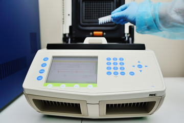 Thermocycler for DNA and PCR tests and analyzes against the backdrop of a medical laboratory