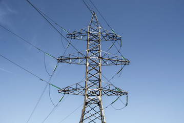 High-voltage line tower at the blue sky, support of power lines