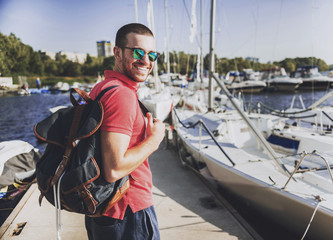 Obraz premium Young Happy Smiling Man in Glasses in Yacht Club.