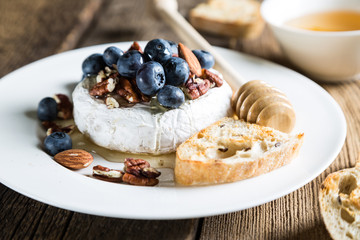 Camembert cheese with honey, nuts and fresh blueberries