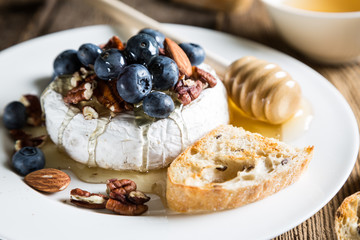 Camembert cheese with honey, nuts and fresh blueberries