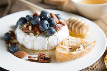Camembert cheese with honey, nuts and fresh blueberries
