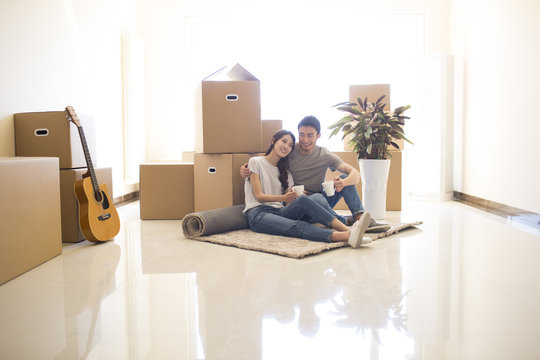 Happy young couple moving to a new house