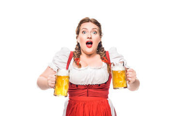 shocked oktoberfest waitress in traditional bavarian dress with mugs of light beer isolated on white background