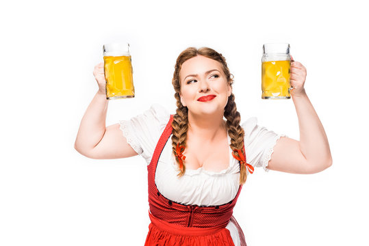 Smiling Oktoberfest Waitress In Traditional Bavarian Dress Showing Mugs Of Light Beer Isolated On White Background