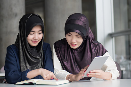 muslim woman college students getting back to school; portrait of happy smiling islamic woman students studying in college education; fall, winter back to school concept; asian young adult woman model
