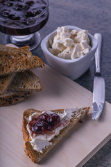 close-up toasts with  jam black currant  and cream cheese on a wooden background