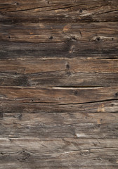 Fototapeta premium closeup of very old brown wooden weathered planks of door or barn