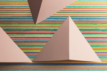 Composition with triangular shapes of paper, colorful lines over background	