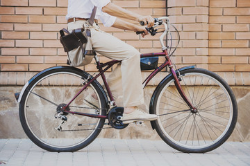 Naklejka premium Close up. Man Sitting on Bicycle Outdoor in Summer